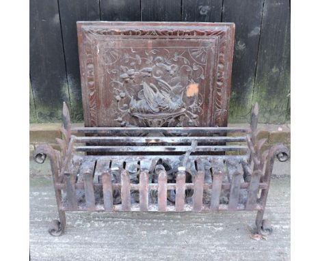 A large wrought iron fire grate, 81cm, together with a carved oak screen