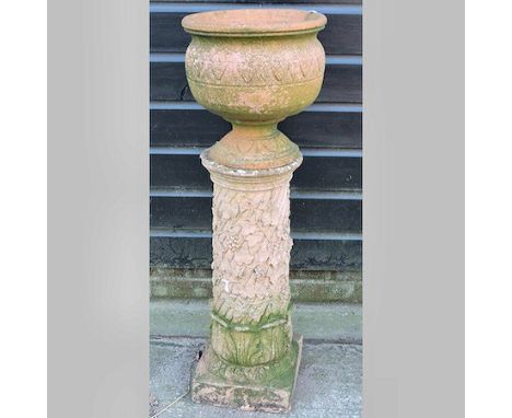 A red terracotta planter, on a column base, 97cm tall