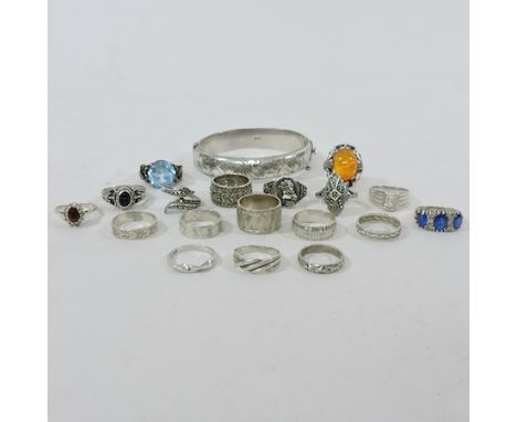 A collection of silver rings and bands, together with a silver bangle