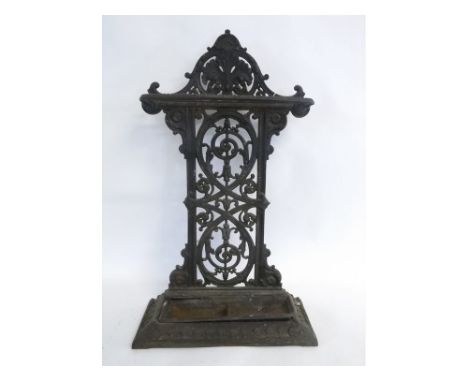 Victorian cast iron stick stand with open work back of scrolling design, together with fitted tray, 46cms wide x 22cms deep x