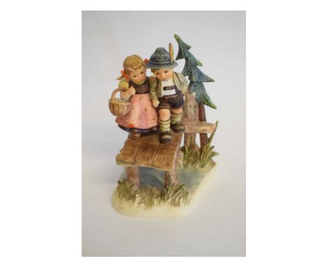 Hummel Goebel figure group, Young girl and boy walking over a planked bridge with tree to foreground, 22cms tall  