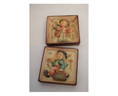 Two framed Hummel Goebel square wall plaques with raised figures of a young boy with a violin and a further young boy with a 