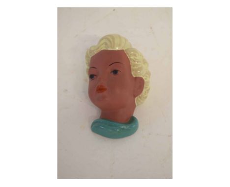 Goldscheider terracotta wall mask of a young girl with blonde hair and a green neck scarf, with printed mark to base, 15cms t