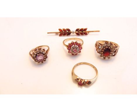 A 9ct gold gem-set bar brooch, 1.7g; a ruby and diamond cluster ring, in 10ct gold, size K 1/2; and three gem-set rings, in 9