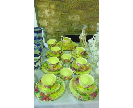 A collection of Crown Staffordshire yellow ground tea wares with printed and infilled pink and yellow floral design comprisin