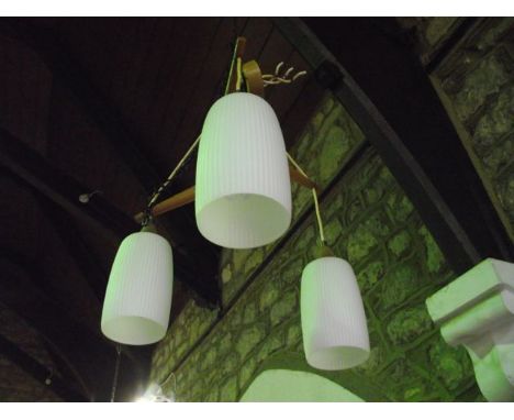 An unusual three branch ceiling light, white cylindrical shades by Timber Stretchers in the Ercol style