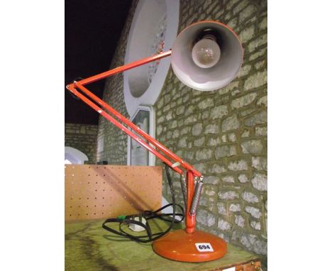 A 20th century Angle poise desk lamp, stamped "Made in England by Herbert Terry & Sons", in overall red colourway