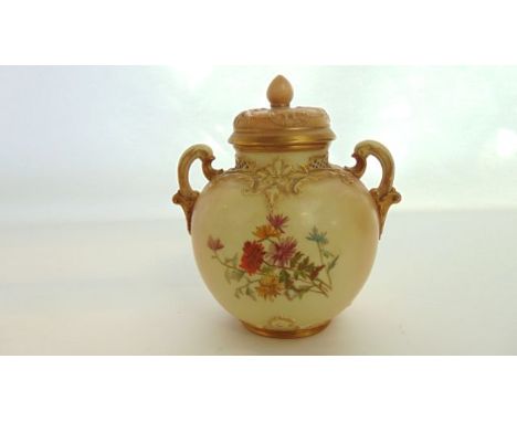 A Royal Worcester blush ivory two handled vase and cover with pierced detail to the neck, painted and gilded chrysanthemum de