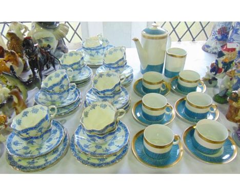 A collection of late 19th century tea wares with blue and white printed floral decoration and shaped outlines comprising a pa