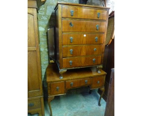 A 1930s walnut veneered chest of five long drawers together with matching dressing table fitted with three drawers on shaped 