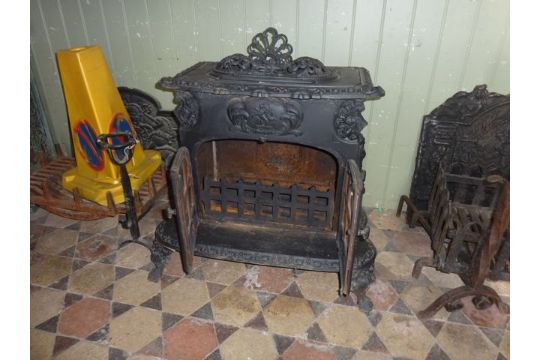 A Substantial And Decorative Cast Iron Wood Burning Stove In The