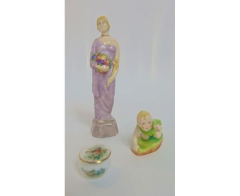 A Royal Worcester model of a blonde haired baby crawling in a green romper suit, with puce printed mark to base numbers 2912 