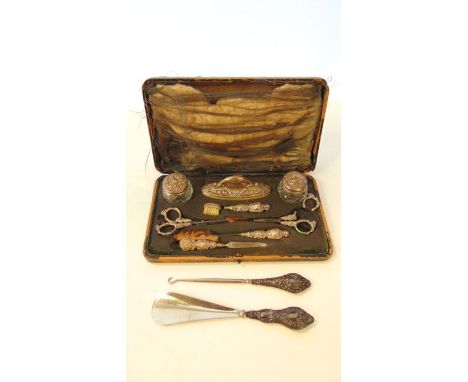 An Edwardian silver cased toilet set, Levi & Salaman, Birmingham, 1909 - 1910, some damage; and a silver-handled button hook 
