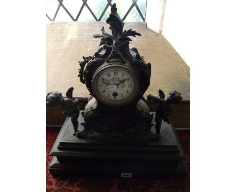 A Victorian cast iron and black slate mantel clock with 8-day timepiece, the decorated cast case with acanthus, floral and ot