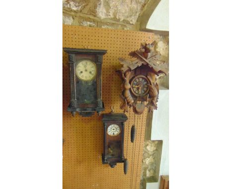 Two 19th century wall clocks each with decorated cases, together with a traditional cuckoo clock with carved timber case