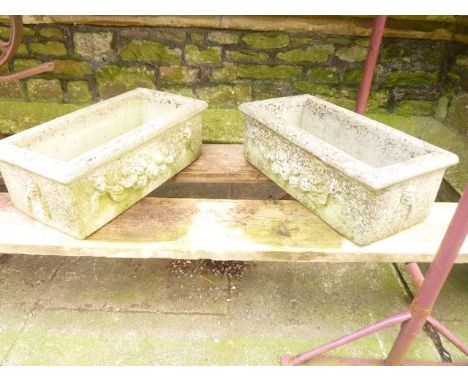 A pair of reconstituted garden planters together with a garden table and two chairs