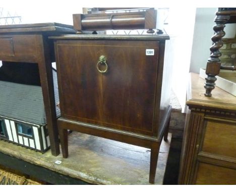 A 19th century mahogany cupboard with fall front with lion mask and ring handles 