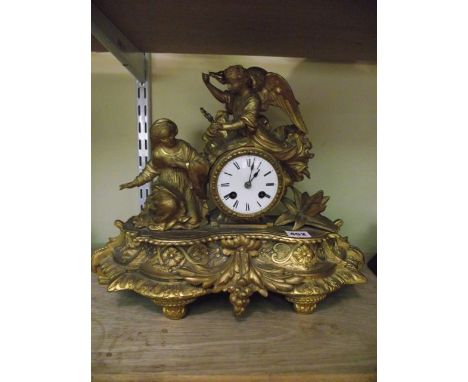 A 19th century gilded spelter mantel clock, the 8-day striking movement surmounted by an angel and a kneeling young lady