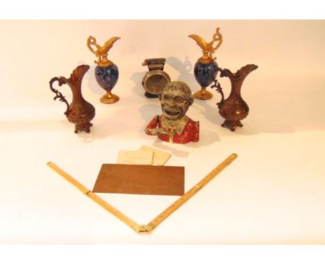 A novelty money bank in the form of a male figure with manoeuvring arm and facial details together with a Lucas Silver King l