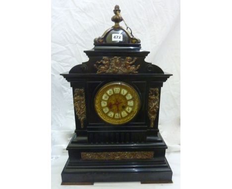 A substantial Victorian black slate mantel clock with applied brass mounts and set beneath a dome, with 8-day striking moveme