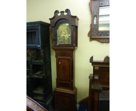 A Regency oak and mahogany longcase clock with turned spindle mouldings, the broken arch brass dial with engraved chapter rin