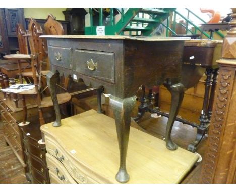 A Georgian oak side table or lowboy fitted with two frieze drawers, with shaped apron and shaped supports, 86cm wide