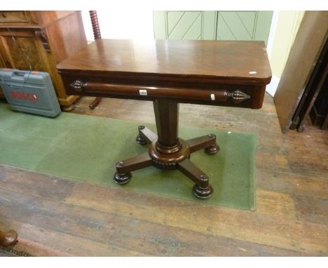 A late Regency mahogany fold over top tea table of rectangular form on an inverted octagonal tapering column on platform base