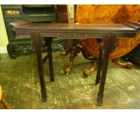 A Chinese alter table raised on four square moulded supports with applied carved detail, 112 cm 