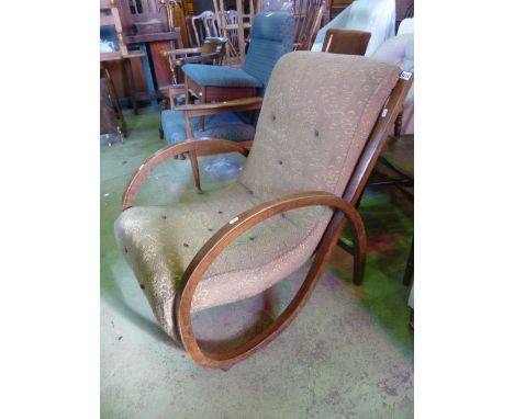 An Art Deco fireside chair with single piece curved framework in beechwood with original upholstery, and a lamp standard