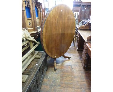 A Regency rosewood tea table of circular form with beaded edge raised on a tapering cylindrical column and platform base, eng