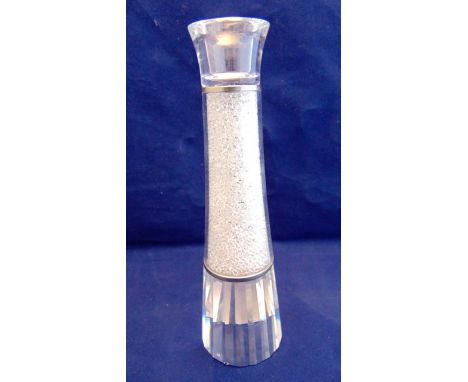 A contemporary Sworovski crystal candlestick with metallic collars, faceted base and crystal filled finish, complete with ori