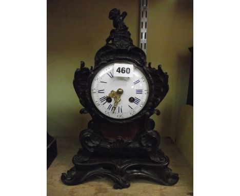 A good quality mid-19th century ormolou mantel clock and stand in the Rococo style with cherub, scroll and other detail, with