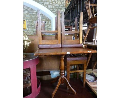 A pub table on turned pillar and quadruped base together with twelve stools in beechwood with tan coloured leather upholstere