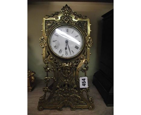 An Art Nouveau mantel clock with cast and pierced brass framework and 8-day timepiece