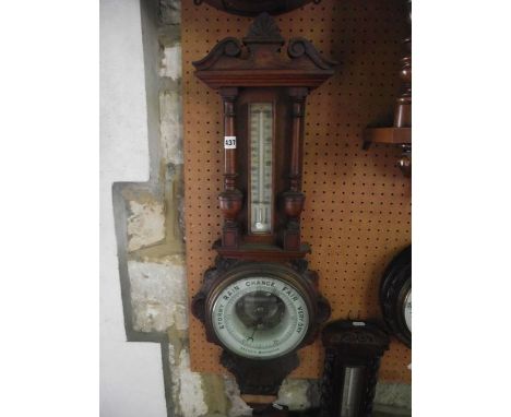 An Edwardian oak barometer, the case with turned column supports and further carved detail, with ceramic dials