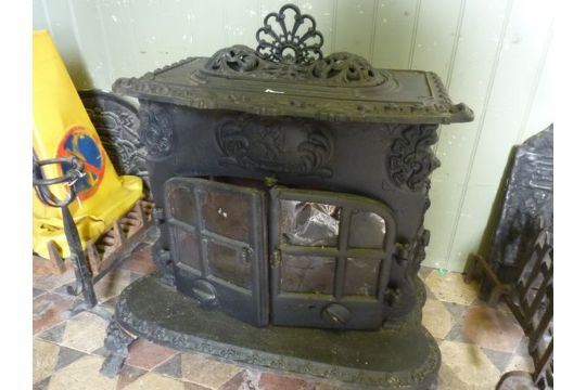 A Substantial And Decorative Cast Iron Wood Burning Stove In The