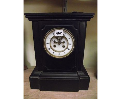 A Victorian black slate and timber mantel clock with enamelled dial, 2-train movement and with visible escapement