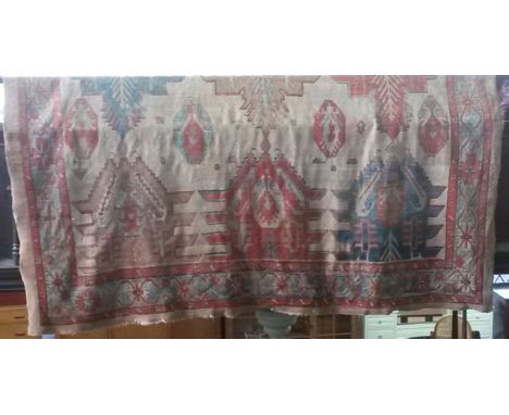 A substantial wool work carpet with multi geometric medallion detail in shades of  light and dark blue, red and amber set upo