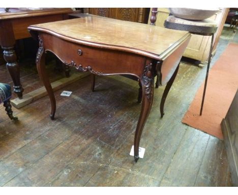 A 19th century plum pudding mahogany centre table of serpentine form fitted with a single frieze drawer flanked by two drop l