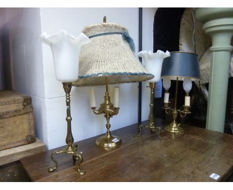 Two Edwardian brass table lamps with tripod bases, a further Georgian style table lamp with adjustable framework and one othe