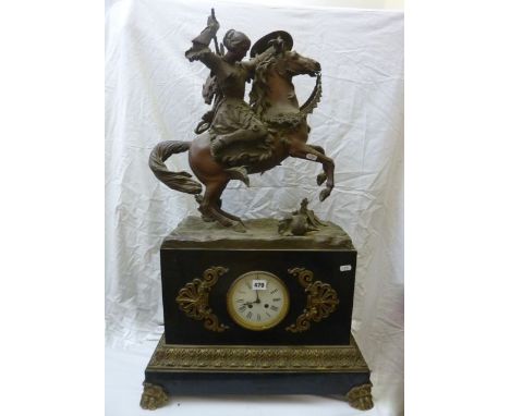 A substantial 19th century black slate, spelter and ormolu mantel clock raised on lions paw feet, enclosing an 8-day striking