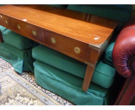 A mid-20th century occasional table of low form and rectangular shape in the military style, fitted with three frieze drawers