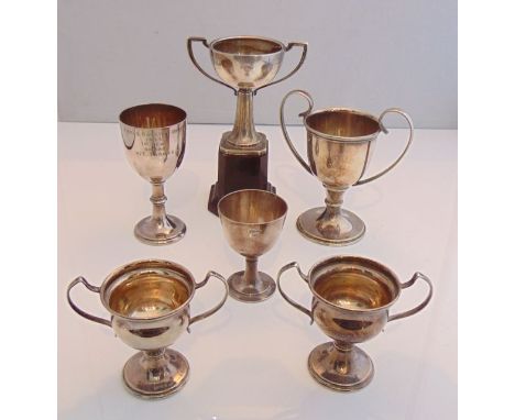 A silver trophy cup, Birmingham, 1932, attached to a plinth, with inscription; and four silver-plated trophy cups; etc