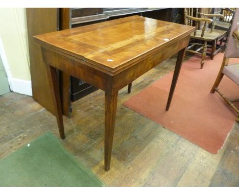 A 19th century continental walnut side table, the top with cross banded borders raised on square taper legs, 107 cm maximum