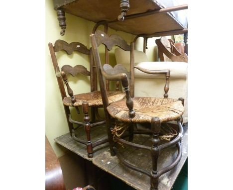 A pair of unusual beechwood ladder back elbow chairs with rush seats, on turned supports and rails