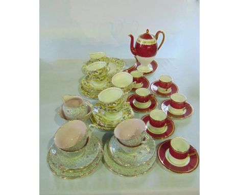 A collection of Wedgwood coffee wares with dark pink speckled glaze and gilded border decoration comprising coffee pot, cresc