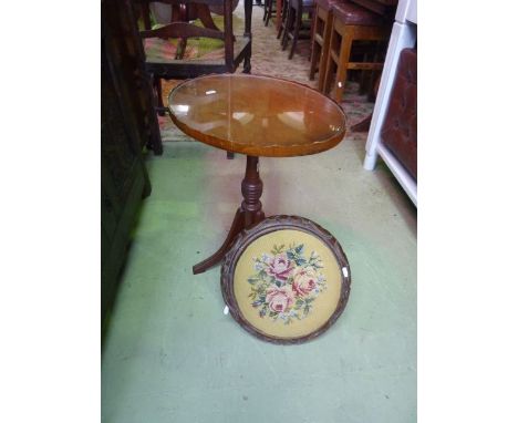 A Victorian footstool of circular form with carved borders and upholstered top and a Georgian style occasional table on turne