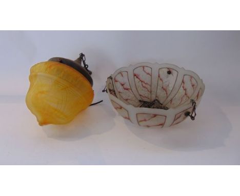An amber tinted mottled glass hanging ceiling light with brass fitting, together with a further mottled shade