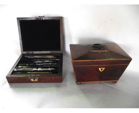 A mahogany veneered caddy with inlay to border, raised on four bun supports, the hinged lid revealing a lidded divisional int