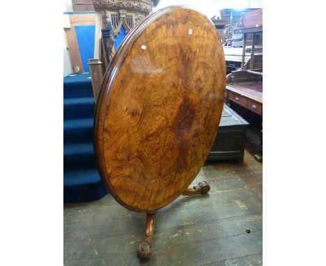 A good quality Victorian figured walnut tea table, the circular top 130 cm diameter raised on a carved pillar and tripod base